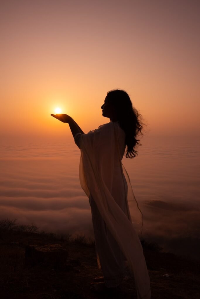 Woman holds the sun in her hand.