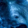 person splashing ice-cold water on their face